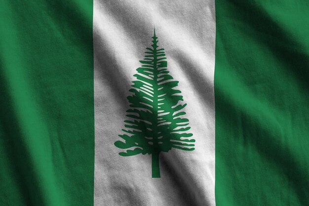 Norfolk island flag with big folds waving close up under the studio light indoors The official symbols and colors in banner