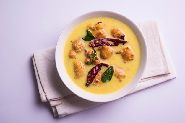 North India's popular food Kadhi Pakoda or pakora with laccha paratha or roti and cooked basmati rice