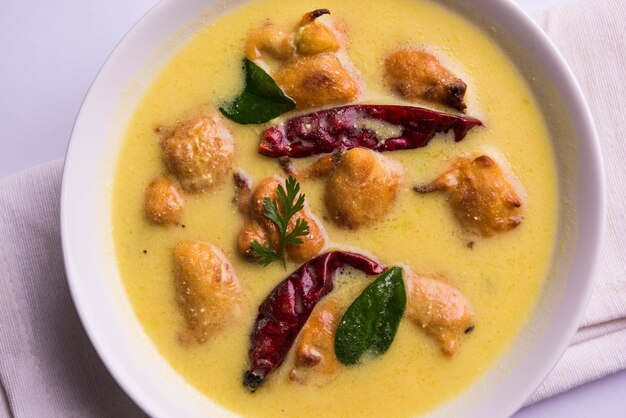 North India's popular food Kadhi Pakoda or pakora with laccha paratha or roti and cooked basmati rice