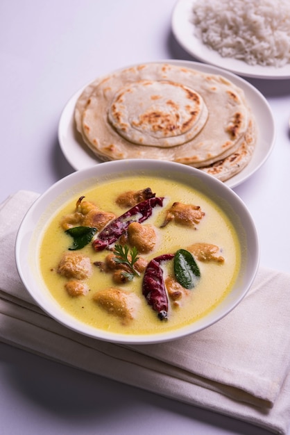 North India's popular food Kadhi Pakoda or pakora with laccha paratha or roti and cooked basmati rice