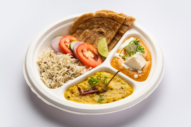 North Indian mini meal parcel platter or combo thali with paneer butter masala roti dal and rice