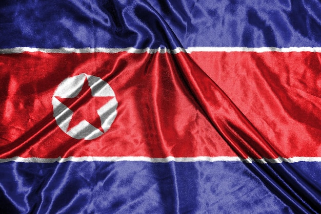 Ткань флага Северной Кореи Атласный флаг развевается Текстура ткани флага