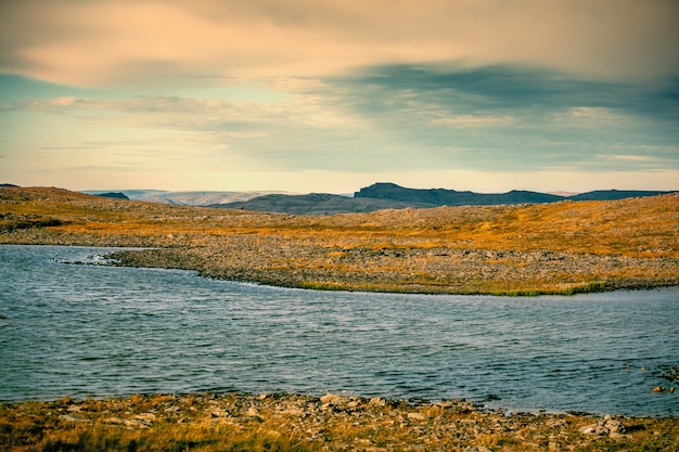 North minimalist landscape. Mountain river in the valley. Beautiful wilderness of Norway