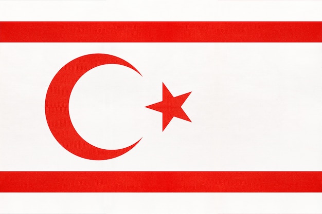 Photo northern cyprus national fabric flag, textile background. symbol of asian world country.