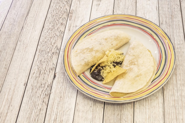 Photo in the northwest and north of mexico quesadillas are grilled or grilled in addition to melted cheese they are usually accompanied by various ingredients