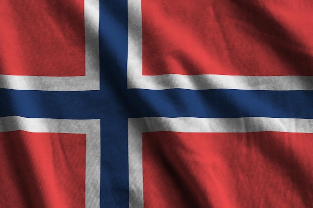 Norway flag with big folds waving close up under the studio light indoors The official symbols and colors in banner