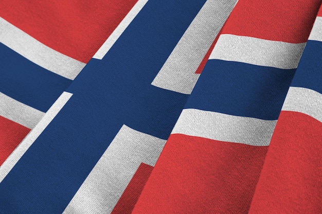 Norway flag with big folds waving close up under the studio light indoors The official symbols and colors in banner