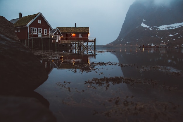 Norway rorbu houses and mountains rocks over fjord landscape scandinavian travel view Lofoten