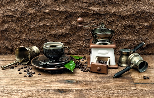 Nostalgic still life with cup of coffee and antique accessories. Vintage style toned image