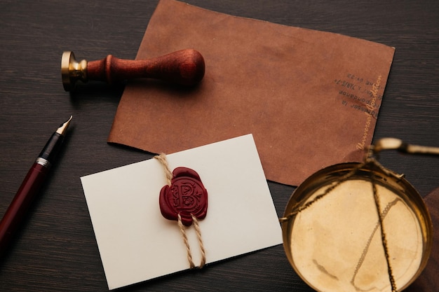 Photo notary stamp scale and envelope with wax seal on a wooden table notary tools