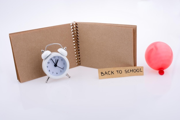 Note book balloon and an alarm clock