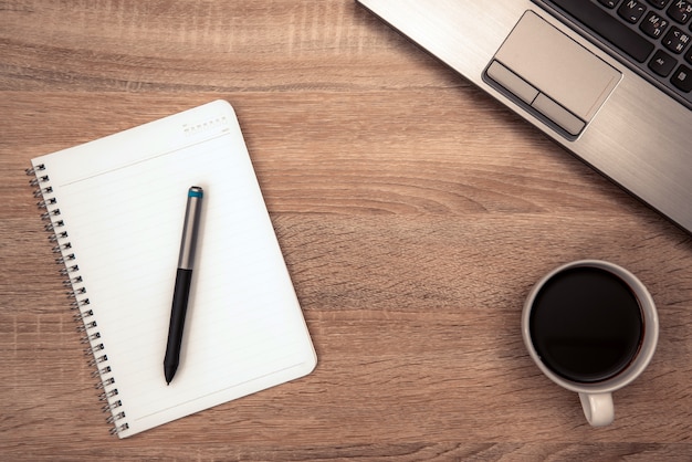 Photo note and cup of coffee on working table