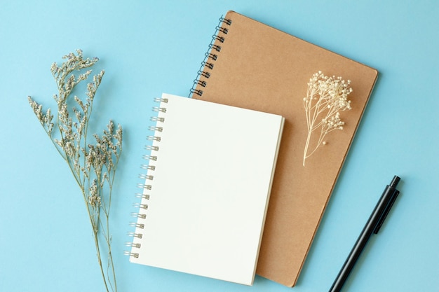 note pad on blue background flat lay top view
