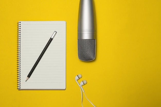 Note pad and microphone on the Color Background