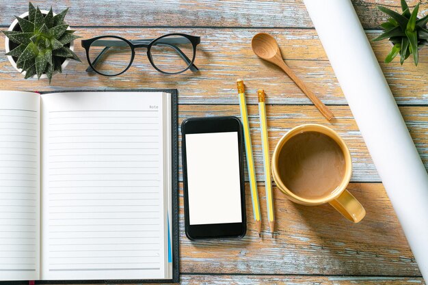 Note pad and mobile phone on the desk and coffee mug