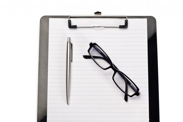 Note pad, pen and glasses on a white background