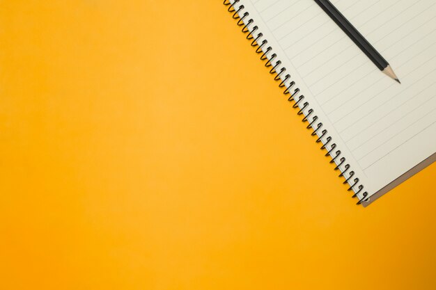 Note pad and pencil on the Color Background