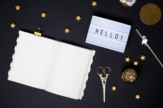 Notebook on a black table with a gold details