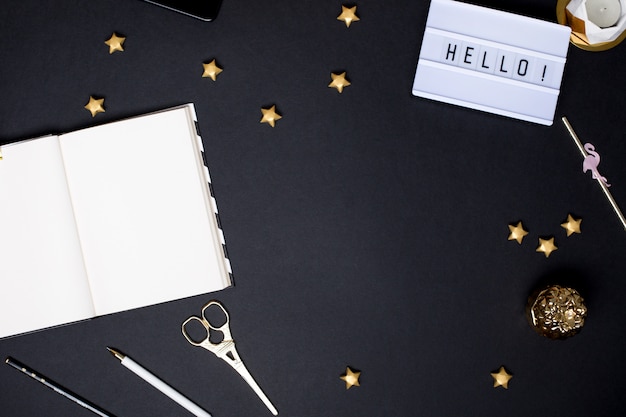 Notebook on a black table with a gold details