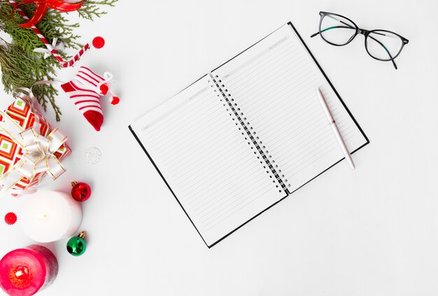 Foto notebook vuoto aperto natale, pigne di abete rami candela piatto lay sfondo