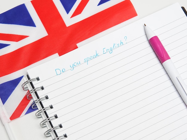 Photo notebook and british flag close up english language education