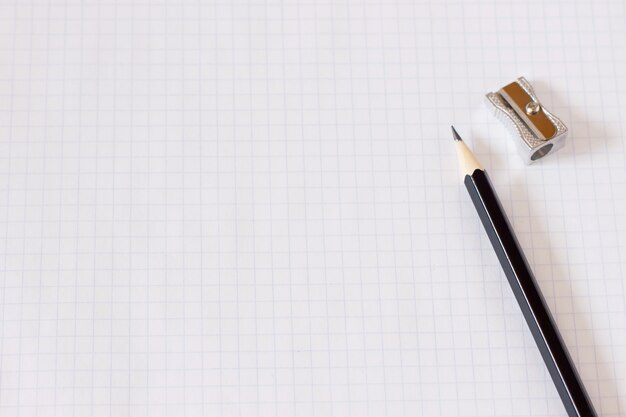 Notebook in a cage with a pencil close-up, blank for the designer, business plan