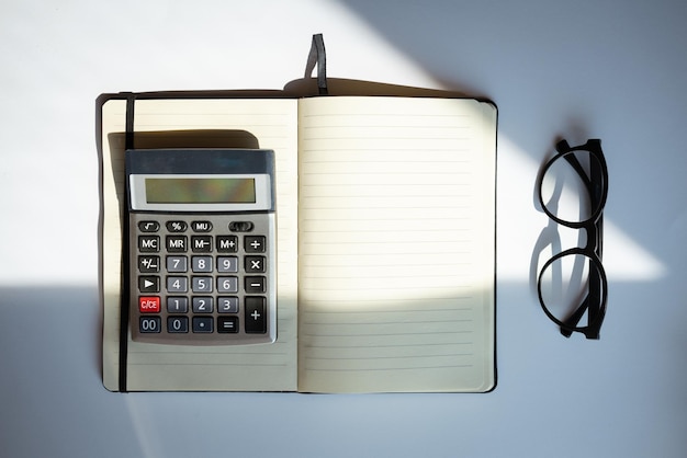 Notebook calculator and glasses