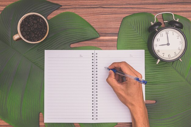 Notebook and coffee mug On the desk