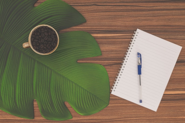 Notebook and coffee mug On the desk