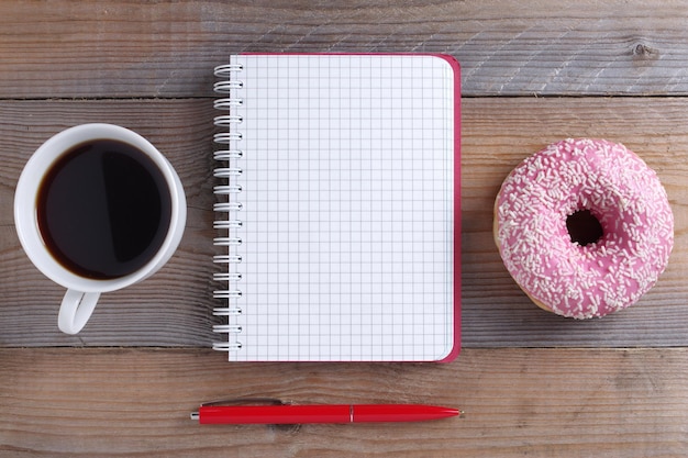 Notebook and donut with coffee