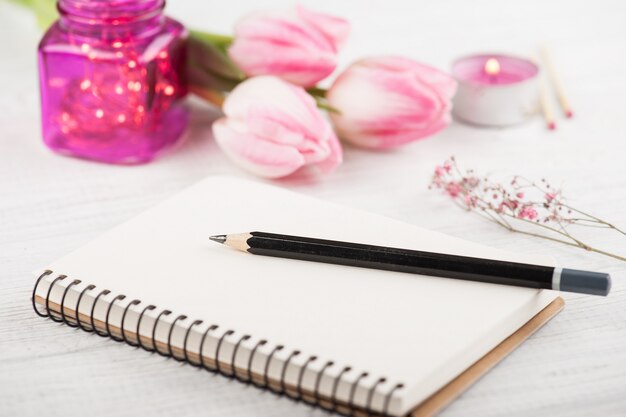 Notebook, flowers and pink lights