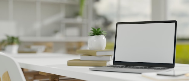 Notebook laptop mockup and decor on a white table in modern coworking room