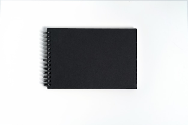 Notebook mock up with clean black blank for design and advertising. Notepad with chromed spring and free copy space template. On the gray background.