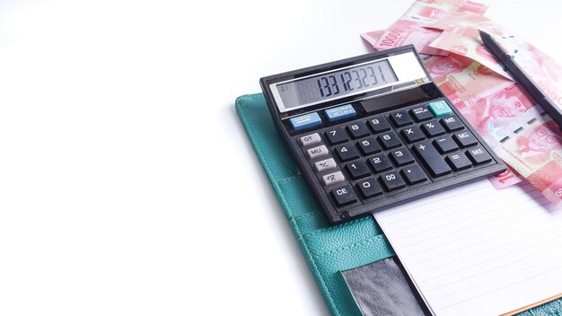 Notebook money and calculator on desk Copy space photo