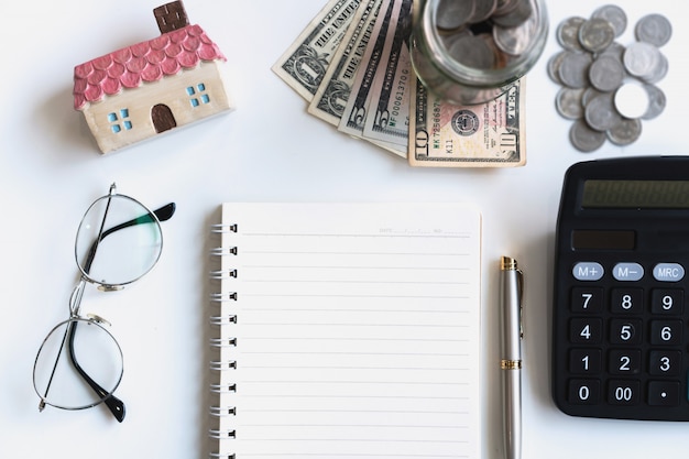 Photo notebook, money and calculator on desk