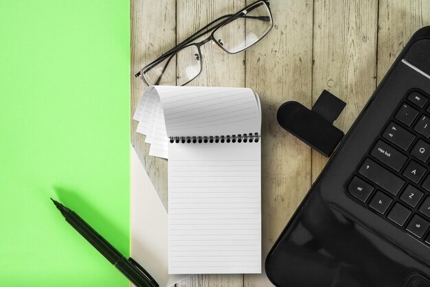 notebook notepad and eyeglasses on wooden table