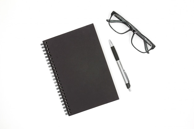 Notebook, pen and glasses isolated on white background.