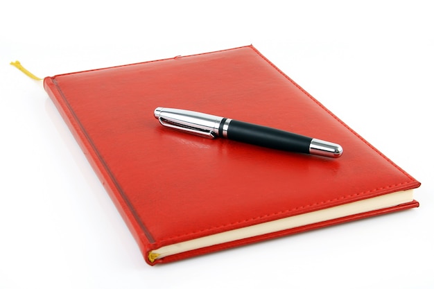 Photo notebook and pen isolated on a white background