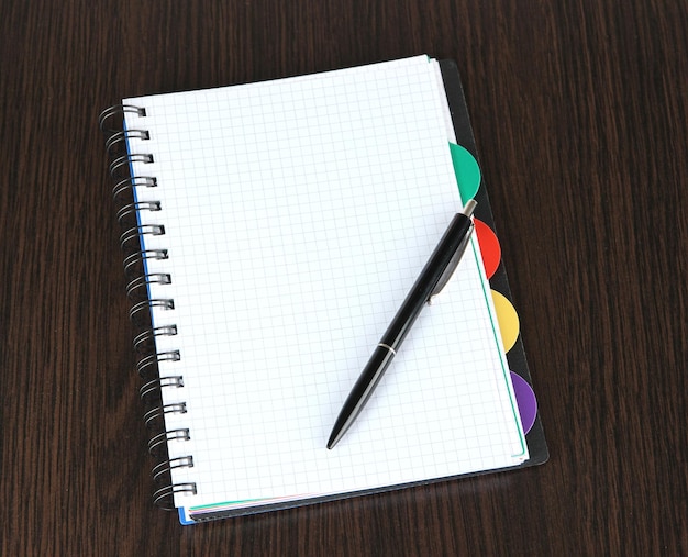 Notebook and pen on wooden table