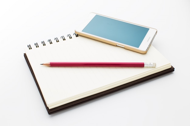 Photo notebook, phone and pencil isolated on white background.