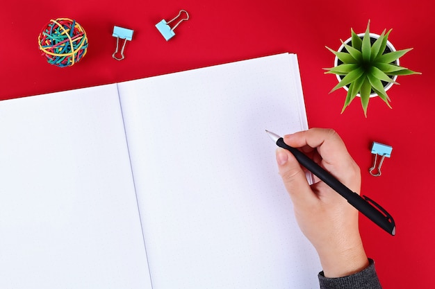 Notebook on a red background.