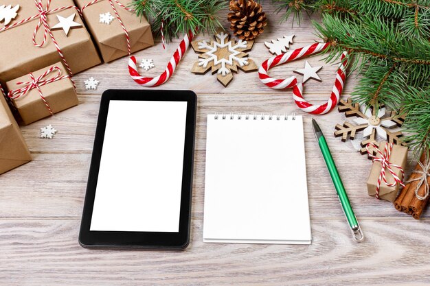 Notebook tablet branding mock up for christmas time, Christmas decor on white background, flat lay top view.