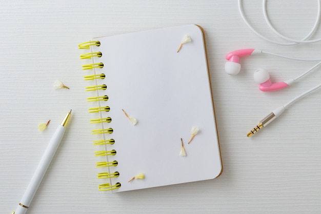 Notebook with flower earphone and pen