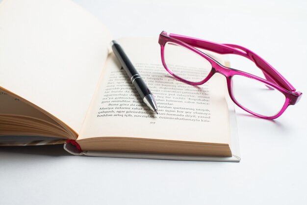 Notebook with glasses and pen