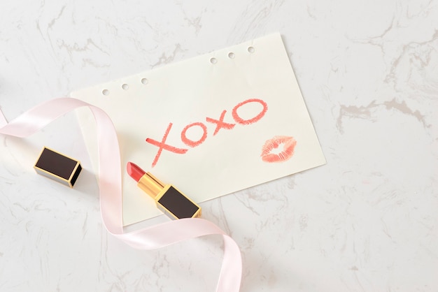 Notebook with Marble surface. XOXO. Glamour style. Flat lay. Red lips.