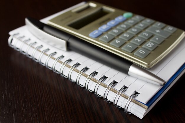 Notebook with pen and calculator.