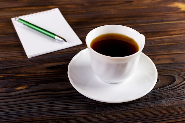 Notebook with pen and coffee cup , business concept