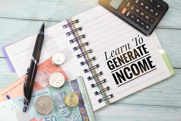 A notebook with a pen and a pen that says learn to generate income.