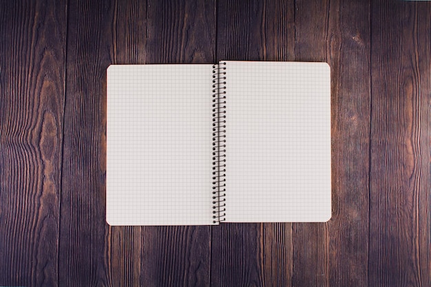 Notebook with pen on a wooden table