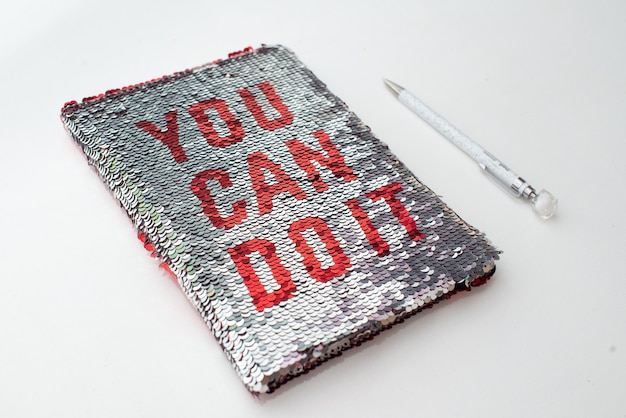 A notebook with the red inscription-you can do it